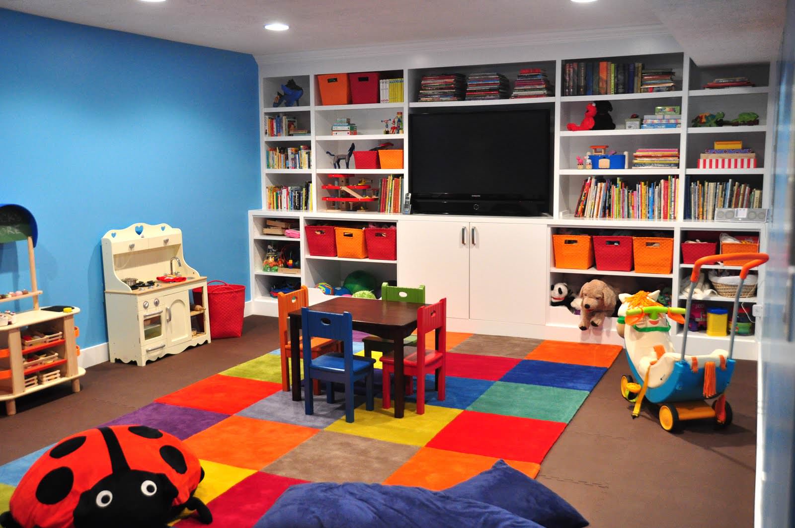 patchwork-rug-of-bright-multicolored-squares-built-in-storage-and-flatscreen-TV