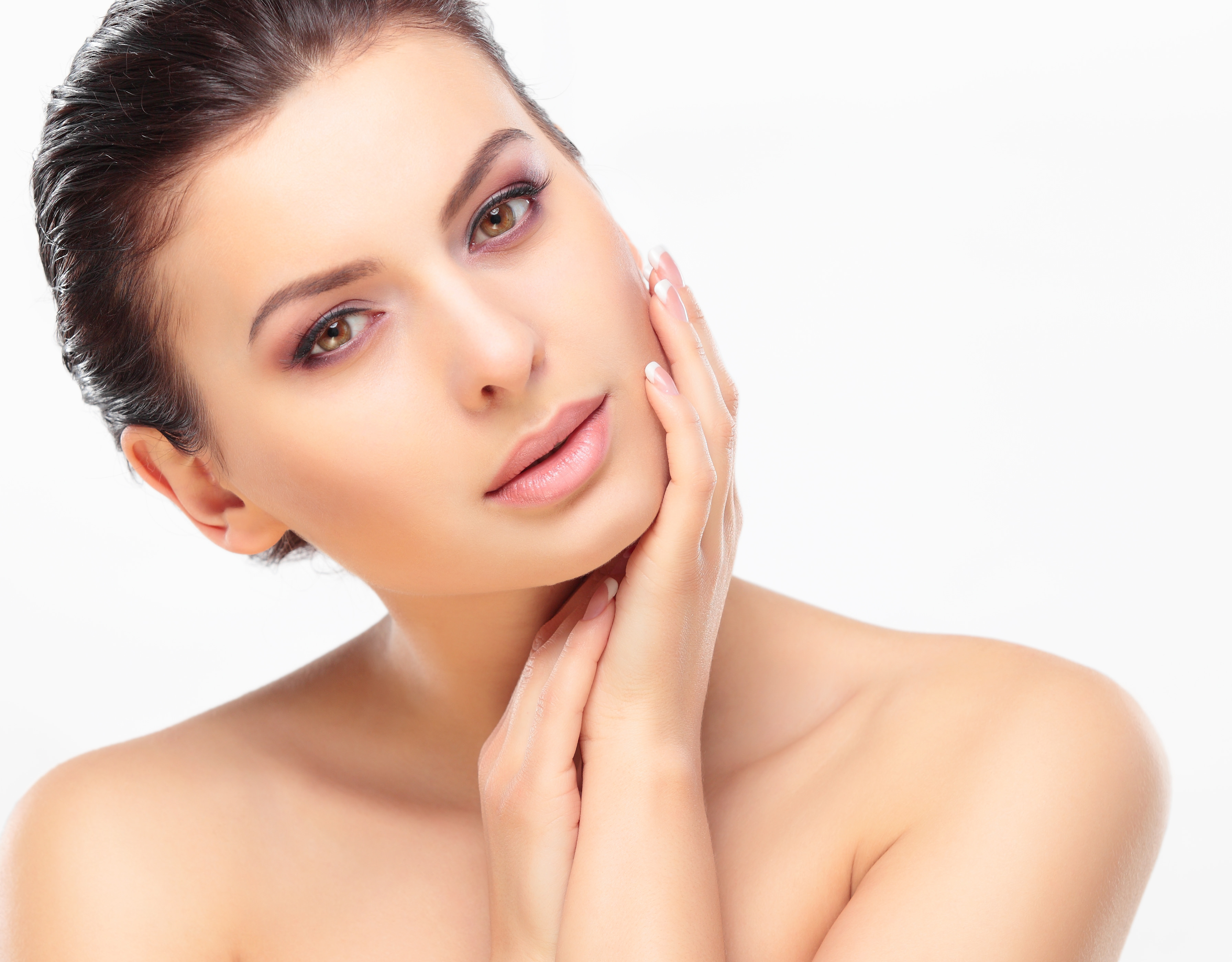 Beautiful Girl Touching Her Face. Isolated on a White Background. Perfect Skin. Beauty Face. Professional Makeup