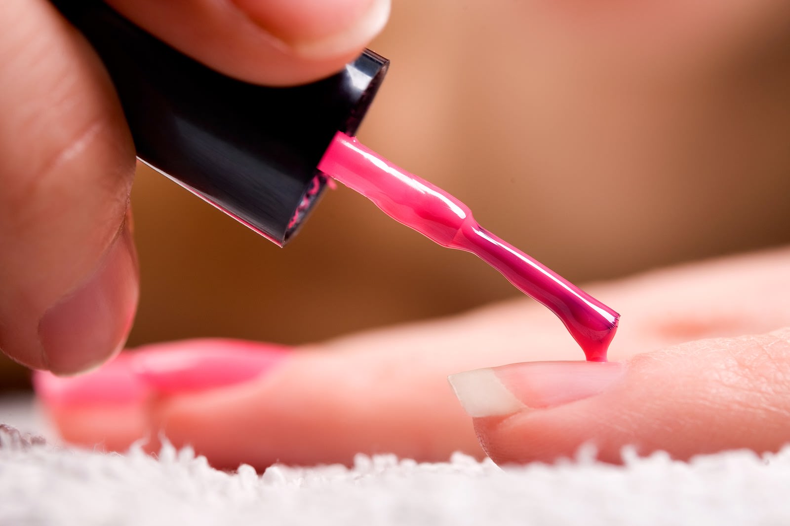 bigstock-Woman-applying-red-nail-polish-17561453