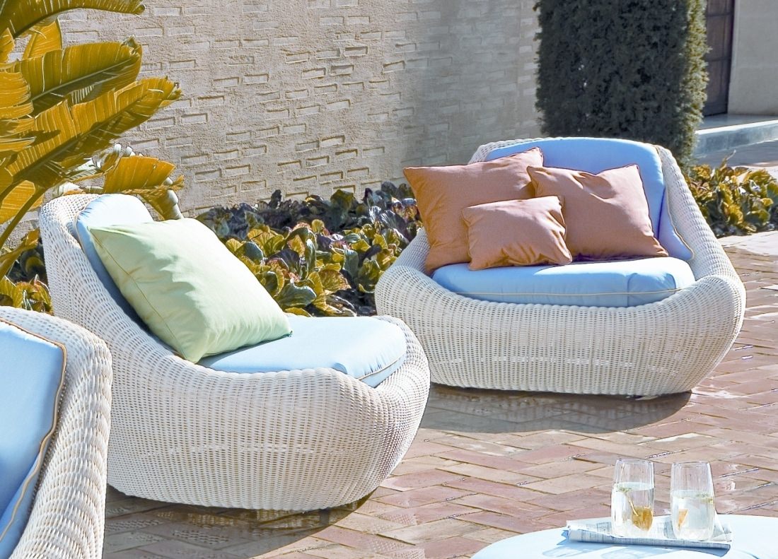 modern-pool-affordable-furniture-using-rounded-design-white-rattan-patio-chairs-with-blue-upholstered-cushions-and-orange-pillow