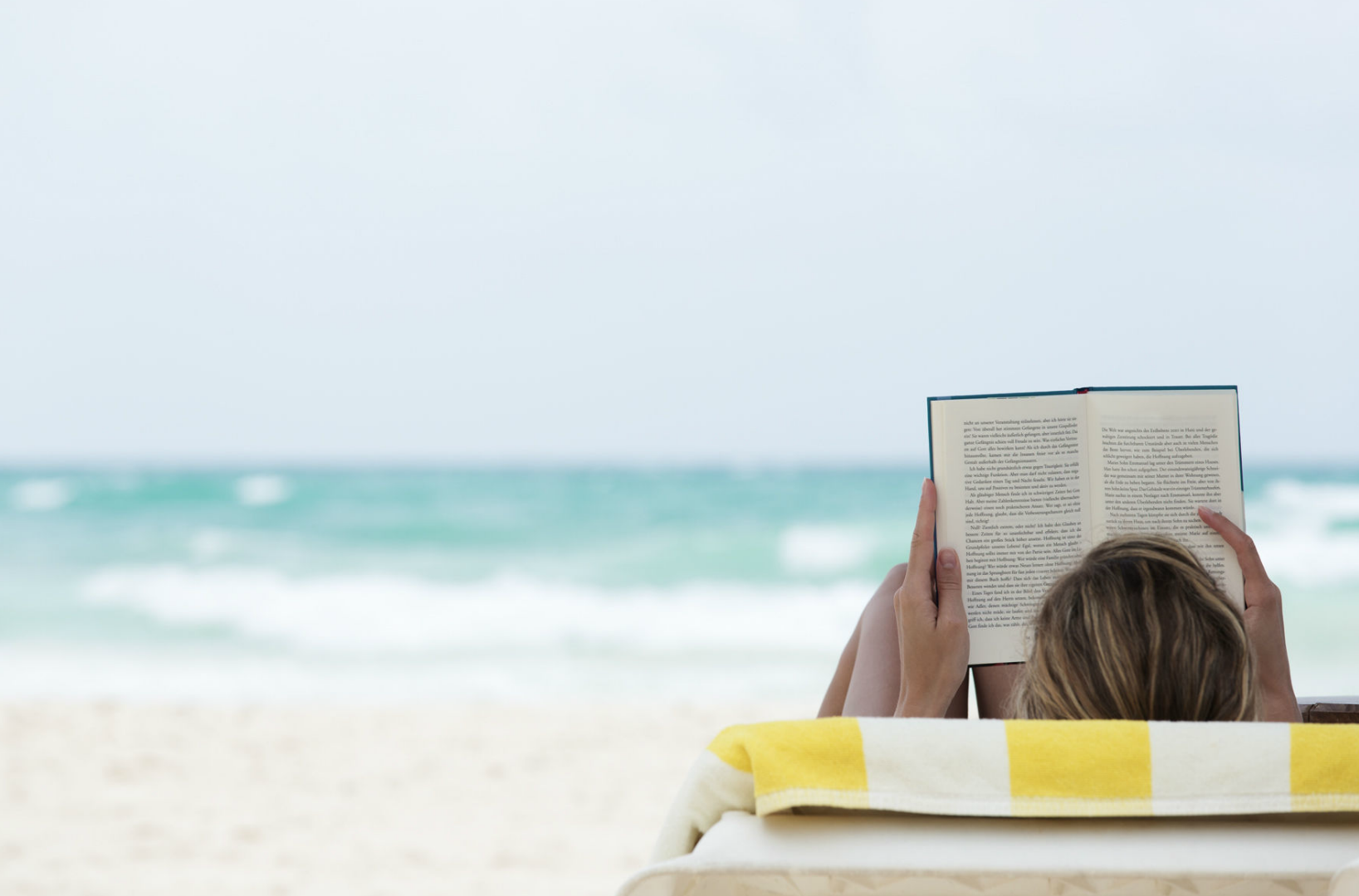 woman-reading-on-the-beach