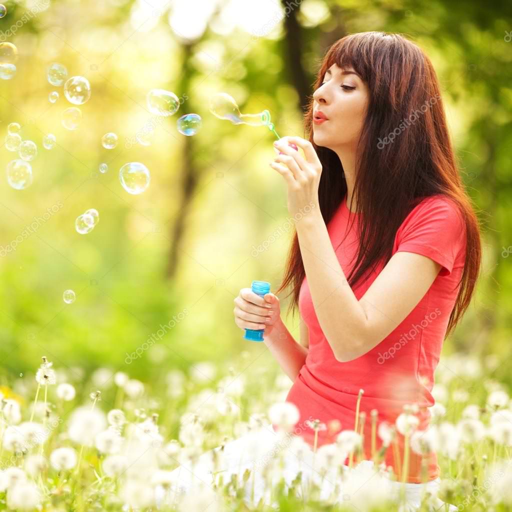 depositphotos_18047913-stock-photo-happy-woman-blowing-bubbles-in