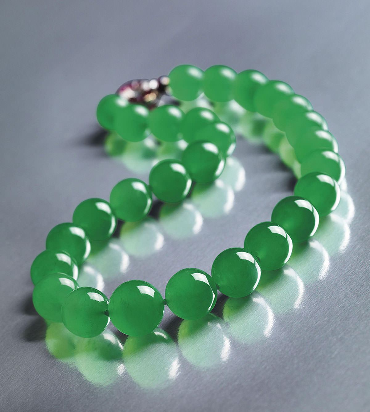 The Hutton-Mdivani Necklace, comprised of 27 enormous Qing jadeite beads with an Art Deco ruby and diamond clasp by Cartier