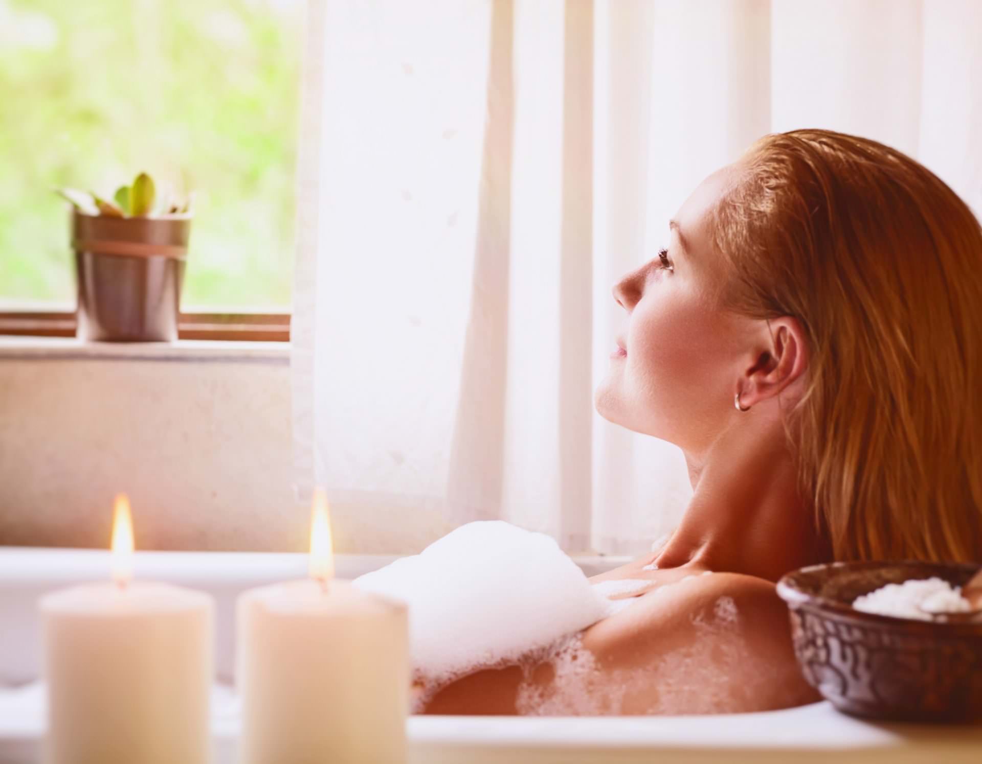 Woman relaxing in bathtub
