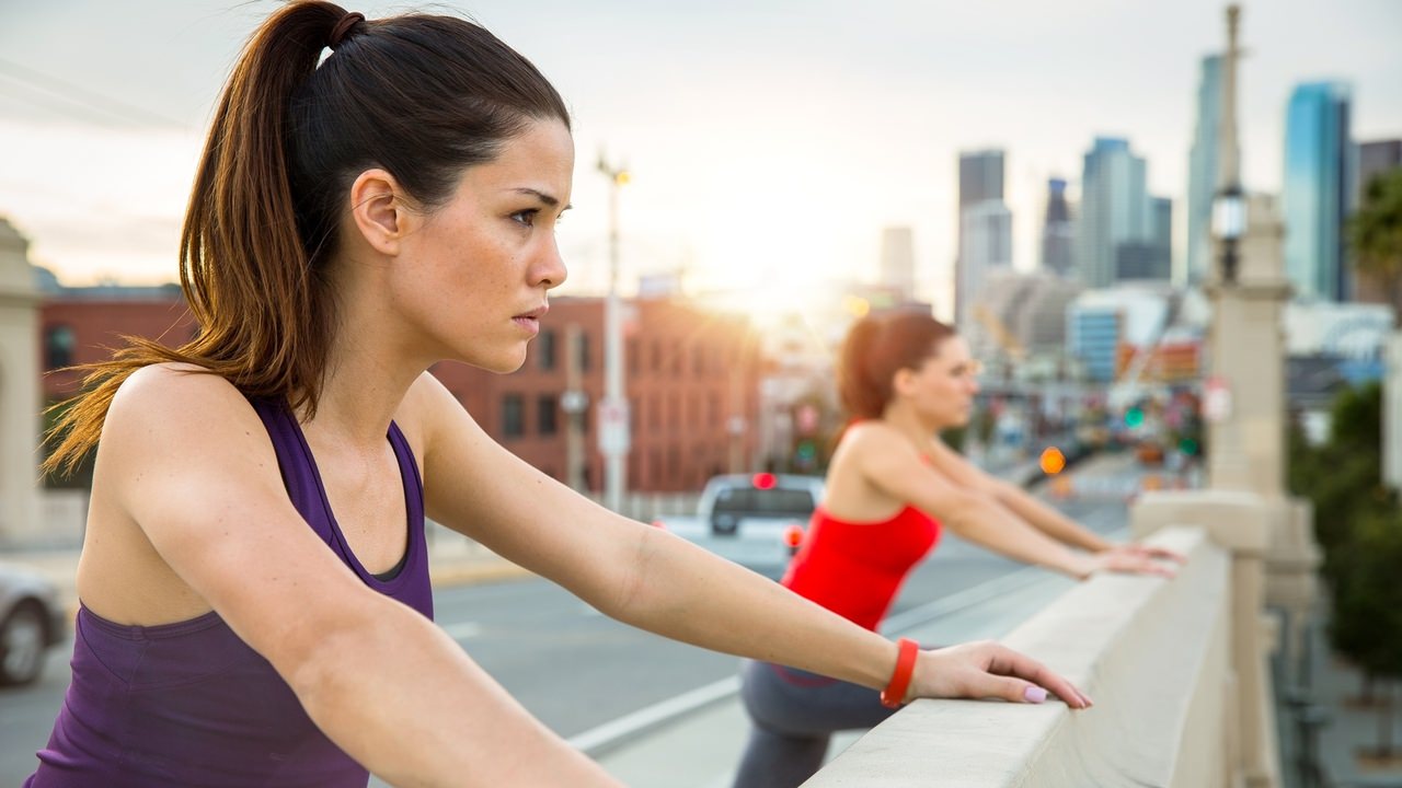 Morning sunrise exercise outdoor city urban skyline beautiful women group stretching resting