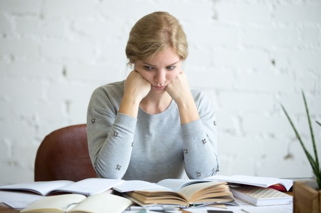 portrait-of-a-tired-student-woman-at-the-desk_1163-2561