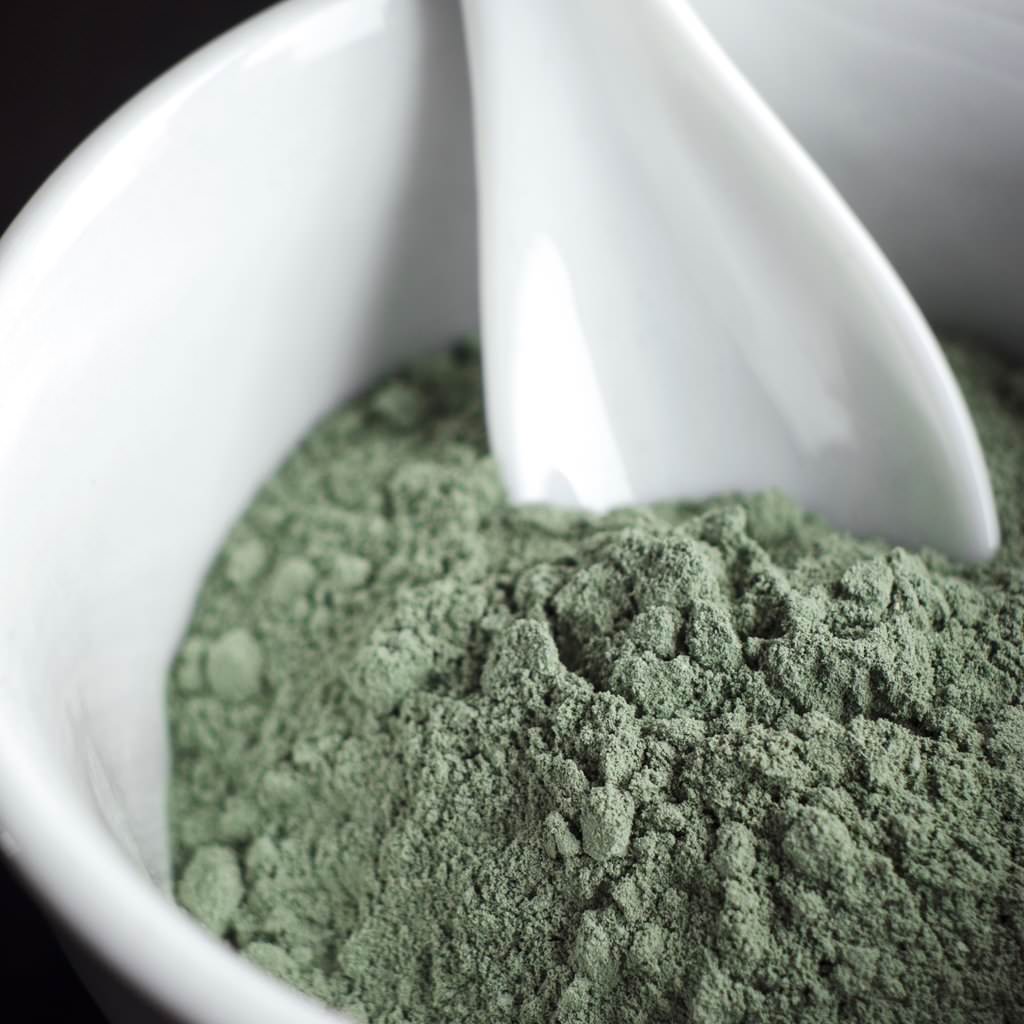 Green facial clay in a bowl
