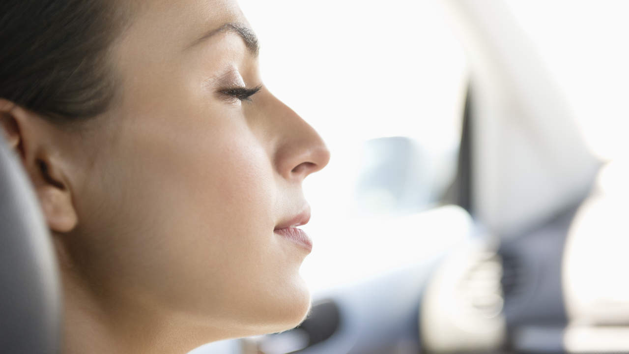 Young woman sleeping in a car