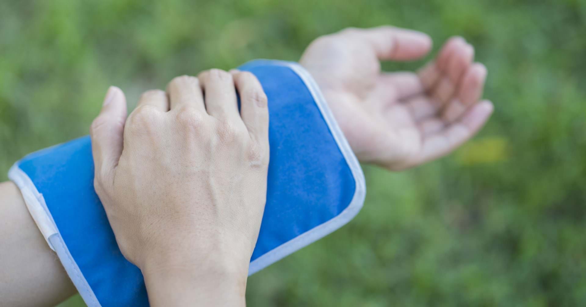 woman putting an ice pack on her arm pain