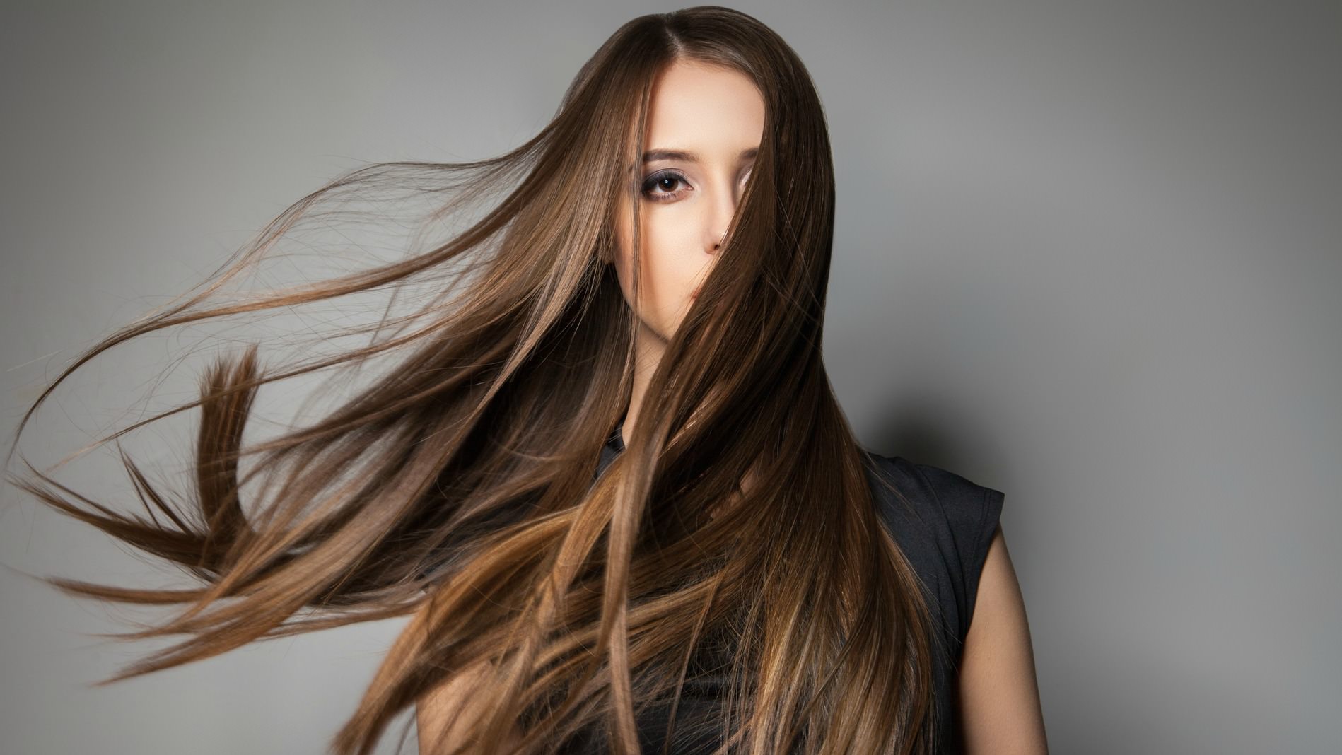 Portrait of calm emotionless model with long windy hair.Studio shot.