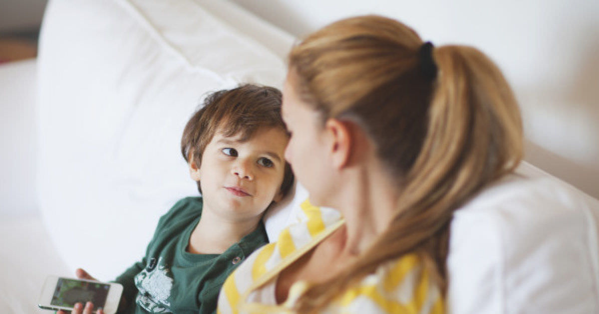 Small boy talking to his mother