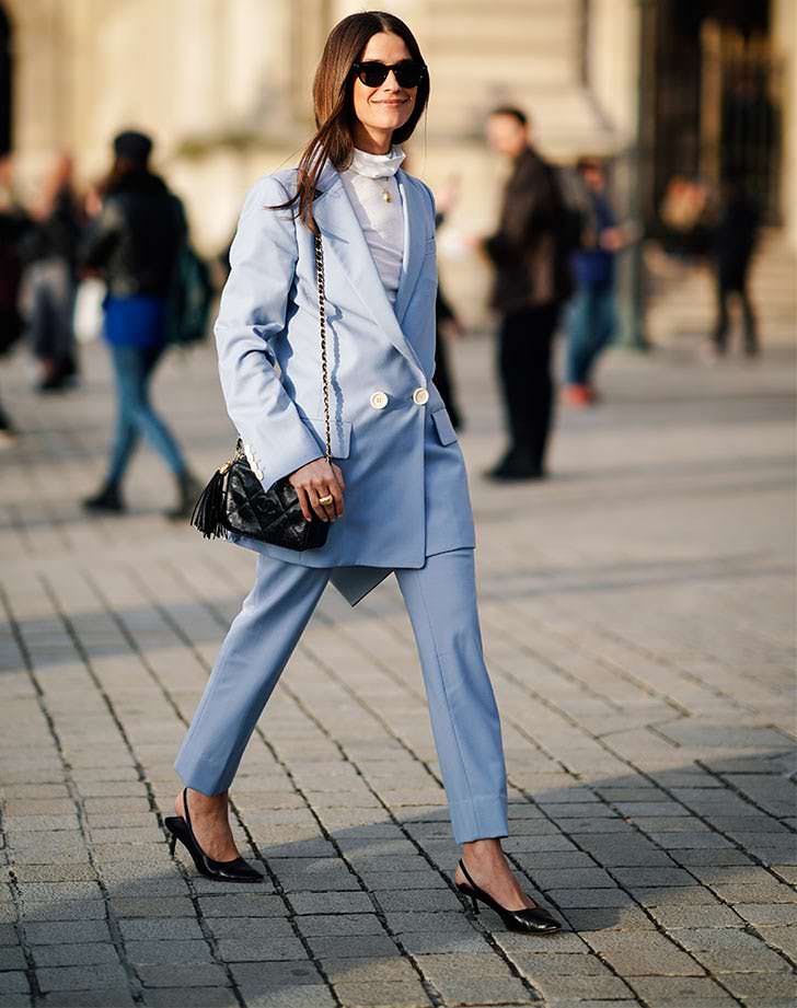 woman-wearing-blue-suit-with-black-leather-bag