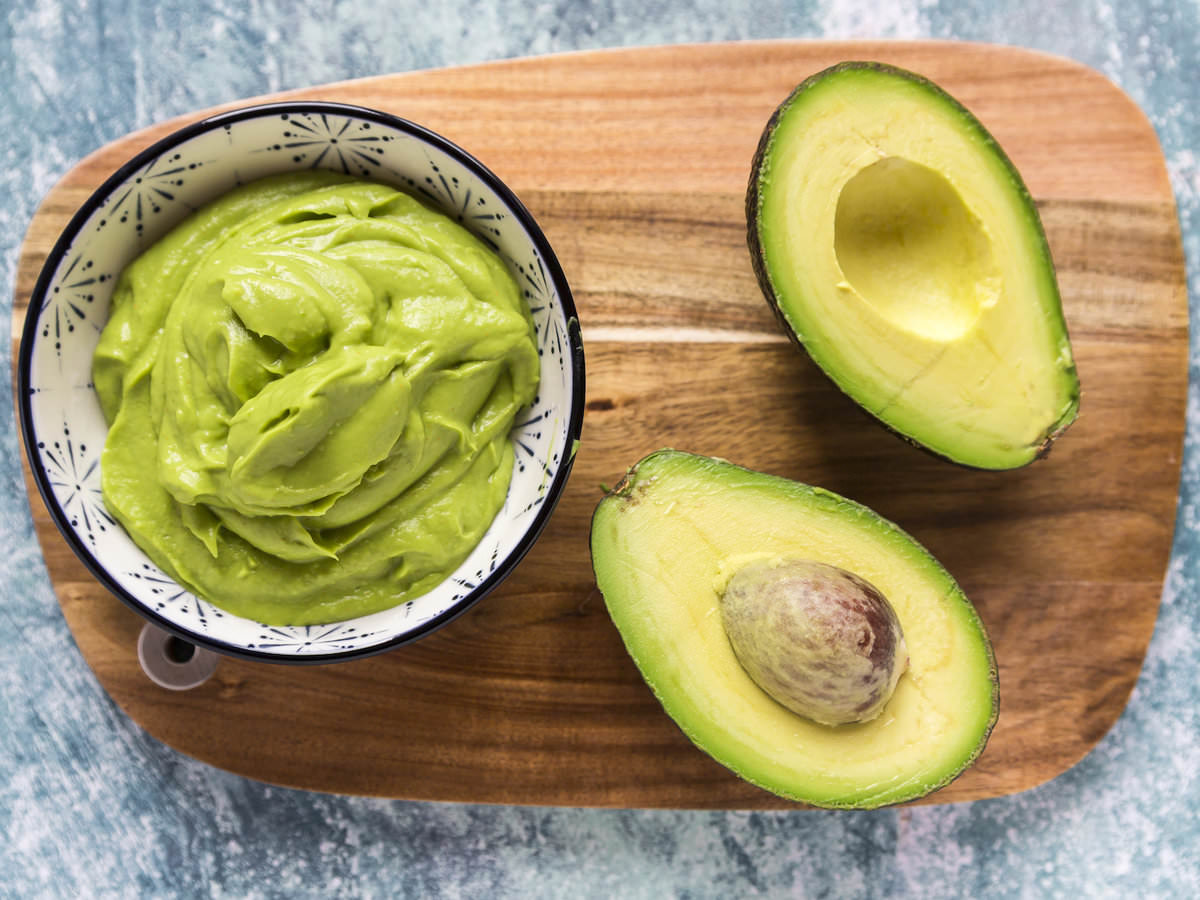 Bowl of guacamole and sliced avocado